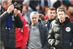  ?? — AFP photo ?? Manchester United’s Portuguese manager Jose Mourinho (C) arrives for the English Premier League football match between Manchester United and Bournemout­h at Old Trafford in Manchester, north west England, on March 4, 2017.