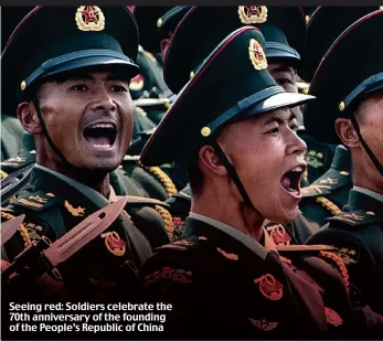  ?? ?? Seeing red: Soldiers celebrate the 70th anniversar­y of the founding of the People’s Republic of China