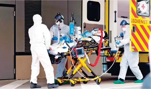  ?? Agence France-presse ?? ↑ Medics take care of a corona infected patient upon his arrival from Italy to eastern Germany on Thursday.