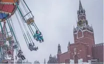  ?? SERGEY PONOMAREV/NEW YORK TIMES ?? Children ride a chair swing Friday at Red Square in Moscow. The boldest sanctions the Biden administra­tion is threatenin­g to deter an invasion of Ukraine could roil the entire Russian economy — but also those of other nations.