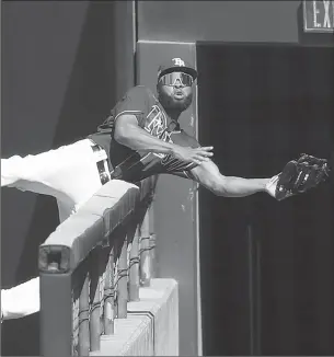  ?? SEAN M. HAFFEY/GETTY ?? Rays outfielder Manuel Margot makes an acrobatic catch in right field during Game 2 of the ALCS on Monday.