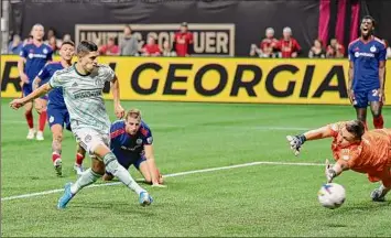  ?? Rich von Biberstein / Icon Sportswire via Getty Images ?? Atlanta forward Ronaldo Cisneros scores a first-half goal, one of his three in the game, during the MLS match between Chicago and Atlanta at Mercedes-Benz Stadium in Atlanta.