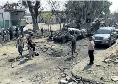  ?? GETTY IMAGES ?? Yemeni men and security forces inspect the damage in the aftermath of an attack claimed by Islamic State in Aden, Yemen, on Monday.