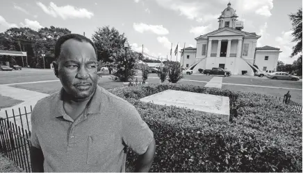  ?? [MICKEY WELSH/MONTGOMERY ADVERTISER] ?? Lowndes County Commission­er Robert Harris stands near the spot where a Confederat­e monument once stood in Hayneville, Ala. In June, the county commission unanimousl­y voted to remove the monument, erected sometime before 1940. Under state law, the county might be made to pay $25,000 for its action.