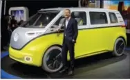  ?? THE ASSOCIATED PRESS ?? Herbert Diess, chairman of the Volkswagen brand, poses with the I.D. Buzz all-electric concept van, at the North American Internatio­nal Auto Show in Detroit on Monday.