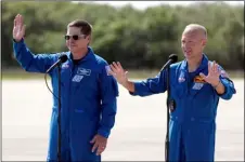  ?? AP PHOTO/JOHN RAOUX ?? NASA astronauts Bob Behnken, left, and Doug Hurley wave as they leave a news conference after they arrived at the Kennedy Space Center in Cape Canaveral, Fla., Wednesday.