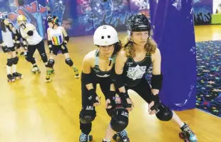  ?? ?? MEMBERS of the Long Island Roller Rebels practice skills at United Skates of America in Seaford, New York. AP