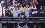  ?? Charles Krupa / Associated Press ?? New York Yankees assistant hitting coach P.J. Pilittere lingers in the dugout after they were defeated by the Boston Red Sox in an American League wild card playoff game at Fenway Park on Oct. 5.