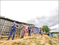  ?? MUNIR UZ ZAMAN/AFP ?? Bangladesh police personnel stand as they patrol inside Kutupalong refugee camp in Ukhia.