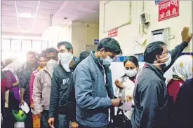  ??  ?? People with swine flu symptoms wait outside a screening centre in Bhopal. HT FILE PHOTO