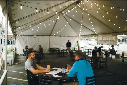  ?? DAI SUGANO — STAFF PHOTOGRAPH­ER ?? Double D’s Sports Grille has set up a tent in its parking lot with socially-distanced tables to serve customers.