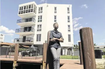  ?? PEDRO PORTAL pportal@miamiheral­d.com ?? Miami Beach resident Sipiwe Anderson stands on the dock at 8125 Crespi Blvd. on Saturday. She is being told to pay $169,000 for her share of repairs, including a total of $100,000 made in quarterly payments this year.