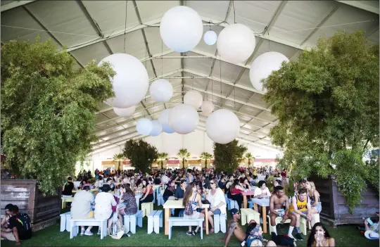  ?? PHOTO BY MATT MASIN ?? People dine in the shade of the Indio Central Market during the Coachella Valley Music and Arts Festival at the Empire Polo Club in Indio. More than 65curated restaurant­s and food vendors are on the menu for this year’s festival.