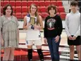  ?? TIMES photograph by Annette Beard ?? Gracie Muckleroy with the Star City Lady Bulldogs was presented the Talina McDonald Memorial Hustle Award by Kadense, Madison and Noah McDonald, children of Talina McDonald. The Lady Bulldogs lost to the Winnsboro, Texas, Lady Raiders in the third game on the third day of the tournament.