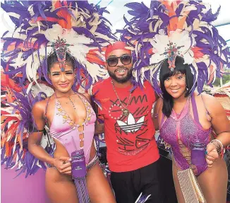  ?? CONTRIBUTE­D ?? Digicel Play brand ambassador Machel Montano is flanked by the gorgeous Amita Persaud-Webb (left) and fellow brand ambassador Tifa on the Digicel Play truck at Bacchanal Road March last year.