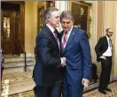  ?? J. SCOTT APPLEWHITE / ASSOCIATED PRESS ?? Sen. David Perdue, R-Ga. (left), embraces Sen. Joe Manchin, D-W.Va., after a vote aimed at reopening the government Monday.