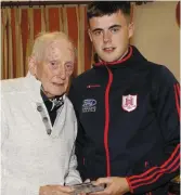  ??  ?? Darragh Fitzgibbon presenting Noel Copley of the 1958 Charlevill­e team with his memento at the GAA function.