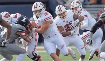  ?? MARK HOFFMAN / MILWAUKEE JOURNAL SENTINEL ?? Former Wisconsin fullback Austin Ramesh (center) helped open plenty of holes for running back Jonathan Taylor last season.