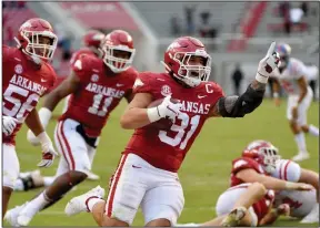  ?? (AP/Michael Woods) ?? Arkansas linebacker Grant Morgan (31) celebrates as he returns an intercepti­on for a touchdown against Mississipp­i last year. Morgan’s decision to come back for another season bolsters the linebacker unit, which is returning intact.