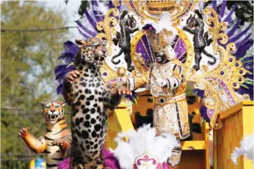  ?? AP PHOTO/GERALD HERBERT ?? King of Zulu Nick Spears rides on a float Tuesday during the Krewe of Zulu Parade on Mardi Gras Day in New Orleans.