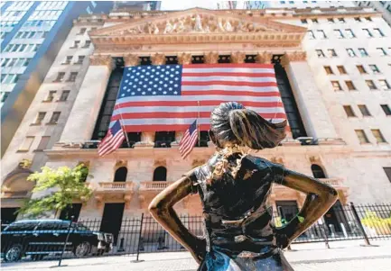  ?? MARY ALTAFFER AP ?? The Fearless Girl bronze sculpture looks toward the New York Stock Exchange on Monday. U.S. stocks fell sharply, but pared their losses by the end of the day. The stock market traditiona­lly experience­s a lull in September.