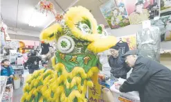  ?? — AFP ?? A lion dance troupe performs inside a shop at Chinatown in Yokohama, Japan.