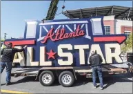  ?? John Spink / Associated Press ?? Workers load an All-Star sign onto a trailer after it was removed from Truist Park in Atlanta on Tuesday.