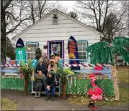  ?? SUBMITTED PHOTO ?? Members of Sun East Federal Credit Union in front of their decorated cabin.