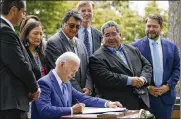  ?? AP ?? President Joe Biden signs proclamati­ons on the North Lawn at the White House in Washington Friday restoring protection­s for two national monuments in Utah and a separate marine conservati­on area in New England.