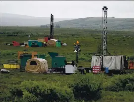  ?? AL GRILLO — THE ASSOCIATED PRESS ?? Workers with the Pebble Mine project test drill in the Bristol Bay region of Alaska, near the village of Iliamma, in 2007.