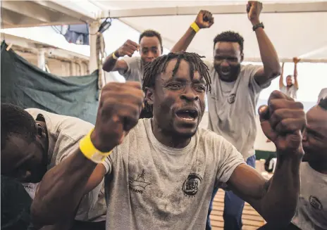  ?? AP ?? Some of the 60 migrants on the Open Arms aid boat as it approached Barcelona, Spain, yesterday