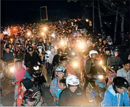  ??  ?? Indonesian riders scrambling to reach higher ground are stuck in traffic Saturday in Cilacap, Java. A magnitude 6.5 quake triggered a tsunami warning, which was later lifted.