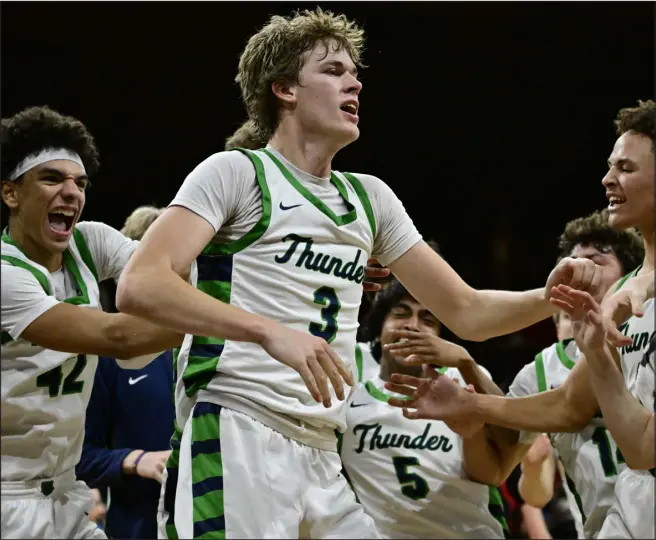  ?? ANDY CROSS — THE DENVER POST ?? Thunderrid­ge Grizzlies teammates swarm Tommy Wight after Wight hit a putback shot to defeat the Eaglecrest Raptors 64-62at the Denver Coliseum on Friday.