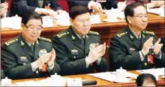  ?? GREA BAKER/AFP ?? Zhang Yang (centre), applauds during the opening session of the National People’s Congress in Beijing on March 5.