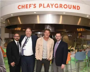  ?? COURTESY OF LIZ OBERACKER ?? Ty Pennington, second from right, unveils the redesign of the dining room at Boston Children’s Hospital, joined by Food Service Director Michael Cogliandro, Vice President of Support Services Henry Tomasuolo and Patient Support Services Senior Director Shawn Goldrick,