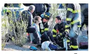  ??  ?? A woman is helped by emergency services crews after she was knocked down by the truck on a bicycle path, left. Right, police survey the aftermath of the attack