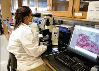  ?? PHOTOS BY KENT D. JOHNSON/KDJOHNSON@AJC.COM 2015 ?? A scientist views evidence in December 2015 at a GBI Division of Forensic Sciences crime lab. The division has almost 93,000 pieces of evidence waiting to be examined. “They are just overwhelme­d with cases,” said the leader of the Prosecutin­g Attorneys’ Council of Georgia.