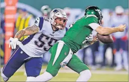  ?? [THE ASSOCIATED PRESS] ?? Jets quarterbac­k Sam Darnold, right, loses control of the ball as he is sacked by the Patriots’ John Simon during Monday’s game in East Rutherford, N.J. Darnold was caught on the sidelines saying he was “seeing ghosts.”