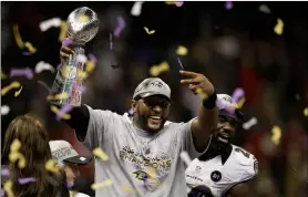  ?? AP PhoTo/elAIne ThoMPson ?? In this 2013, file photo, Baltimore Ravens linebacker Ray Lewis holds up the Vince Lombardi Trophy as he celebrates with free safety Ed Reed (20) after the Ravens defeated the San Francisco 49ers 34-31 in the NFL football Super Bowl 47 in New Orleans.