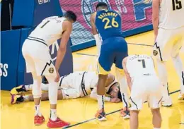  ?? JEFF CHIU/AP ?? The Nuggets were dealt a big blow when point guard Jamal Murray tore the ACL in his left knee in the final minute of Monday’s loss to the Warriors. He’s out indefinite­ly.