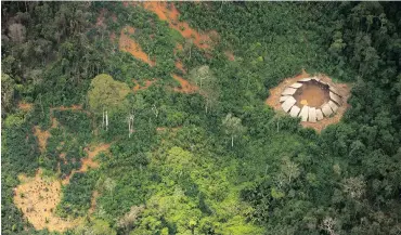  ??  ?? THREATENED: Indians in the Yanomami indigenous reserve. At least three groups are known to be uncontacte­d.