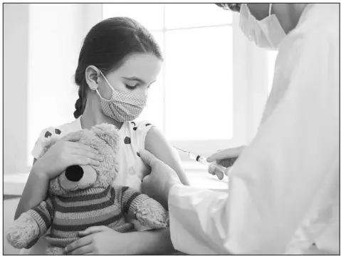  ?? SHUTTERSTO­CK PHOTO ?? A young girl holds a teddy bear while receiving a vaccinatio­n from her doctor. Routine vaccinatio­ns for students in kindergart­en in the U.S. fell to 93% during the 2021-2022 school year.