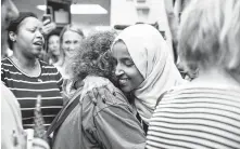  ?? Jenn Ackerman / New York Times ?? Supporters greet Somali-born Democratic Rep. Ilhan Omar at the Minneapoli­s-St. Paul Airport on Thursday after a week of attacks culminated in a chant of “send her back.”