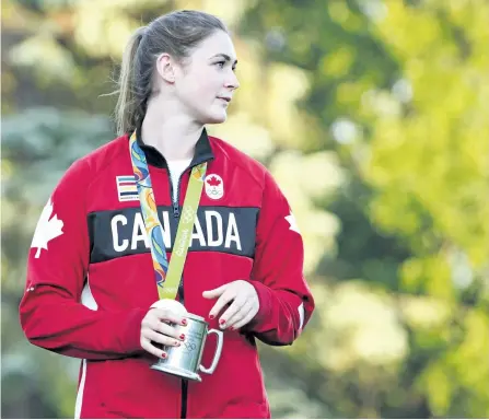  ?? JESSICAN NYZNIK/EXAMINER ?? Olympic rugby player Hannah Darling holds an engraved stein from Peterborou­gh Pagans at Nicholls Oval on Friday night. Darling, a former Peterborou­gh Pagan, was honoured at the rugby club Friday night. See more coverage on Page A1.