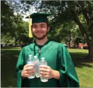  ??  ?? Jackson Hengsterma­n, a member of the Shenendeho­wa High School Class of 2019, is prepared for a hot afternoon at Thursday’s graduation at SPAC.