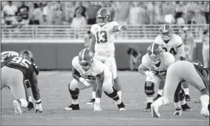  ?? The Associated Press ?? IN THE GAME: Alabama quarterbac­k Tua Tagovailoa (13) directs the offense Saturday during the first half of the Crimson Tide’s 62-7 defeat of Ole Miss in Oxford, Miss.