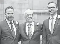  ?? JOHN PHILLIPS, GETTY IMAGES ?? Rupert Murdoch, center, and sons Lachlan, left, and James are no longer protecting executives or anchors accused of bias.