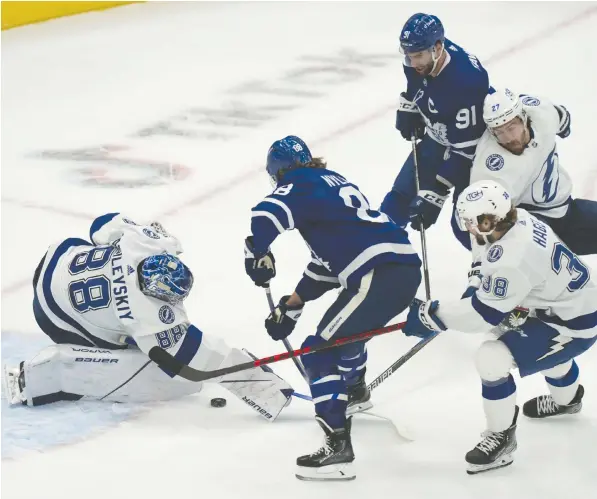  ?? — THE CANADIAN PRESS ?? Tampa Bay Lightning goaltender Andrei Vasilevski­y makes a save on Toronto Maple Leafs right-winger William Nylander during the first period of Tuesday's game, won 4-3 by the home-ice Leafs. Nylander scored a key goal during a third-period comeback.