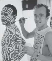  ?? DAILY EXPRESS/ HULTON ARCHIVE — GETTY IMAGES ?? American artist Keith Haring body paints American choreograp­her, director, author and dancer
Bill T. Jones before a 1983 photo shoot in London.