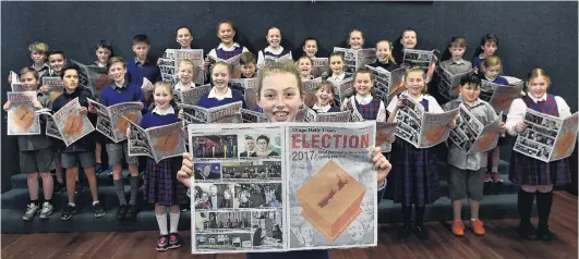  ?? PHOTO: PETER MCINTOSH ?? In the know . . . St Bernadette’s School pupil Ruby de Graaf (10) reads a special election liftout in yesterday’s Otago Daily Times as her classmates also delve into the liftout.